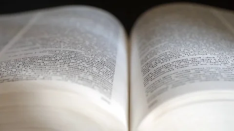 Detailed view of an open book. Refocus the camera shot. Stock Footage 73462167