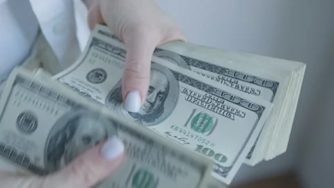 Detailed View of a Person Counting a Stack of One Hundred Dollar Bills Stock Footage 275534606
