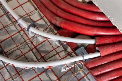 Detailed view of plastic floor heating pipes arranged in continuous loop pa.. Foto stock