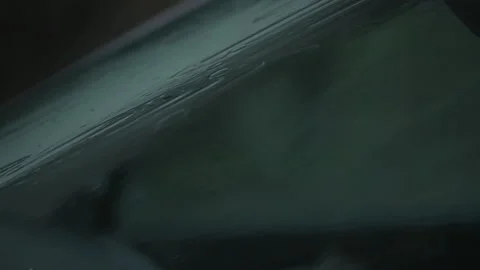Detailed view of rain drops falling onto the windshield Stock Footage 232732511