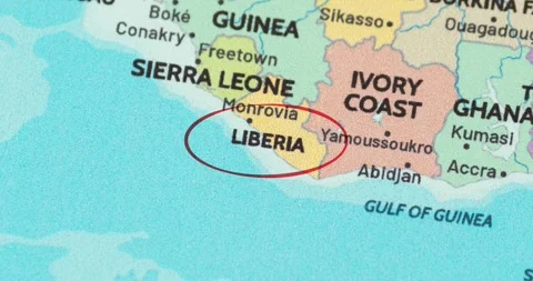 Detailed view of a red circle marking to liberia on a modern political world map Vidéo 348178642