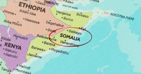 Detailed view of a red circle marking to somalia on a modern political world map Видео 348178898