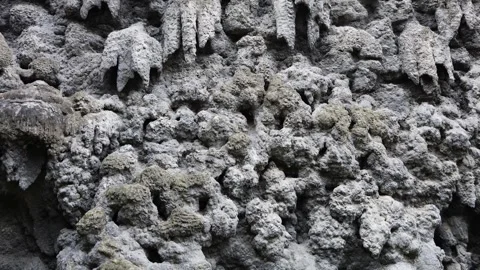 Detailed view of rough stone surface with porous formations resembling natural c Video stock 318869510