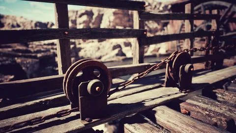 Detailed view of rustic pulleys and wooden beams near a scenic canyon Stock Illustration