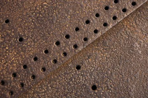 Detailed view of a rusty metallic surface featuring textured patterns Stock Photos