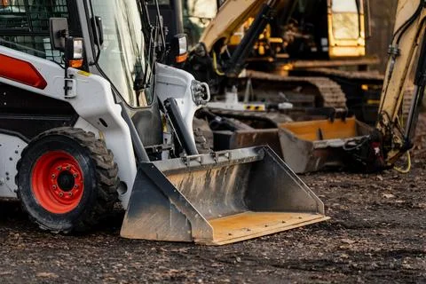 Detailed view of skid steer loader with dirt bucket attachment Stock Photos