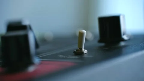Detailed view of tiny switch activation on classic synthesizer panel illuminated Stock Footage 322165172
