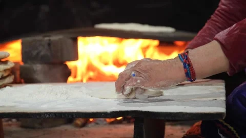Detailed view of Turkish bread cooking on firewood and dough preparation Stock Footage 294173208