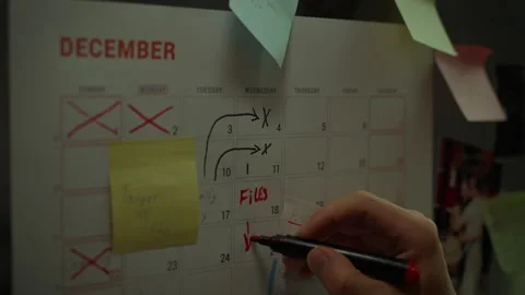 Detailed view of the weekly planner. The palm of a Caucasian makes notes in Stock Footage 281086825