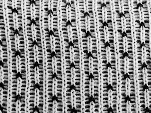 Detailed view of a winter knitting pattern showcasing delicate black stitches Stock Photos