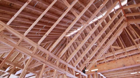 Detailed view of wooden ceiling structure showcasing beams supports in modern Stock Footage 326512474