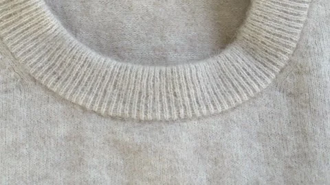 Detailed view of woolen sweater collar emphasizing knit pattern and fabric Stock Footage 332875845