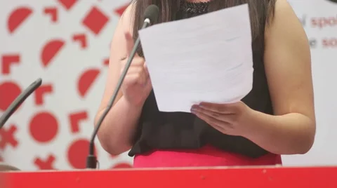 Detailed view at young student making hand gestures while explaining her view on Stock Footage 56911100