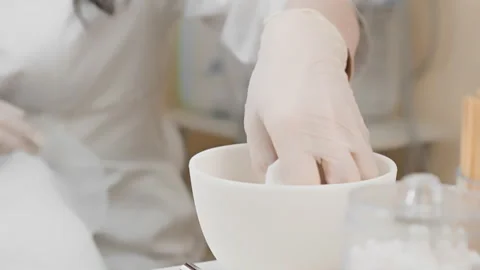 Detailed work in a modern spa setting as gloved hands prepare cosmetic treatment Stock Footage 276667152