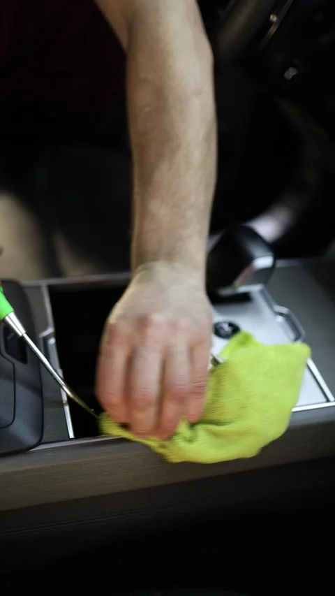 Detailer cleans car interior with compressed air and microfiber cloth Stock Footage 346545113