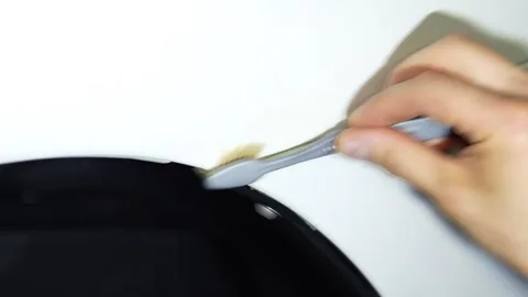 Detailer using a brush to clean dirt from the car fender gap. Video stock 344598137