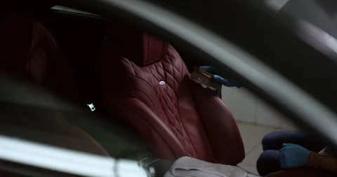 Detailing and cleaning of interior front seats at luxury modern cars. Car care Stock-Footage 94900537