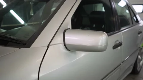 Detailing car. The side mirror of a gray car before polishing. Stock Footage 193431792