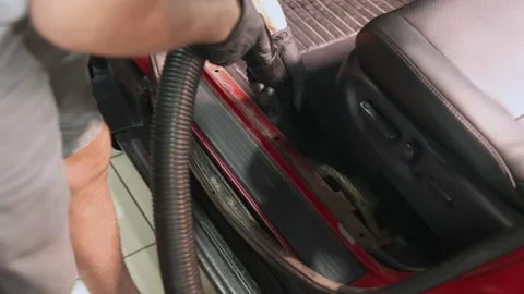 Detailing of a red car. Man cleaning car interior Stock Footage 209119441