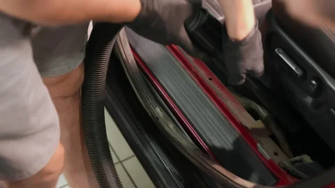 Detailing of a red car. Man cleaning car interior Stock Footage 209119562
