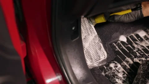 Detailing of a red car. Man cleaning car interior Stock Footage 209119688