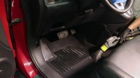 Detailing of a red car. Man cleaning car interior Stock Footage 209119692