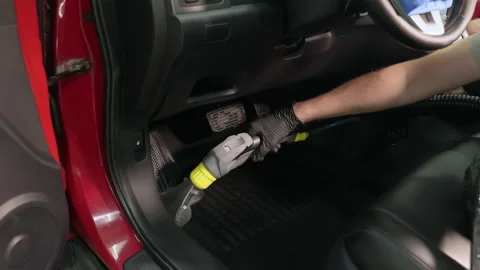 Detailing of a red car. Man cleaning car interior Stock Footage 209119953