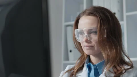 A detailoriented researcher is analyzing complex datasets with a stateoftheart Stock Footage 317024645