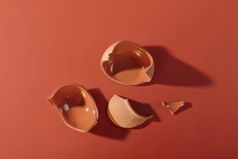 Details of broken ceramic cup on red background Stock Photos