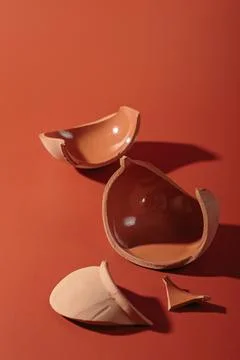 Details of broken ceramic cup on red background Stock Photos