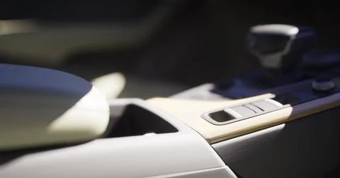 Details of a car interior highlighting the console and gear shifter Illustrazione stock