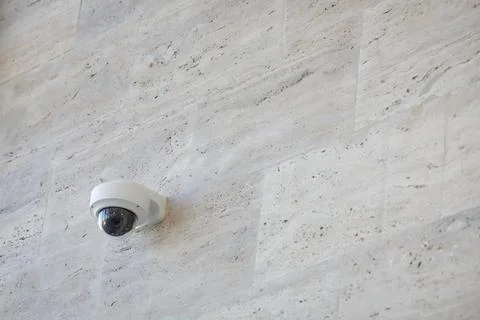 Details with a CCTV camera on a wall inside a building. Stock Photos