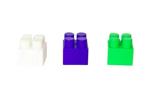 Details of a children's plastic constructor on a white background. colored cu Stock Photos