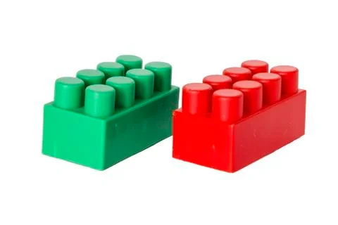 Details of a children's plastic constructor on a white background. colored cu 库存照片