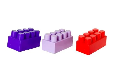 Details of a children's plastic constructor on a white background. colored cu 库存照片