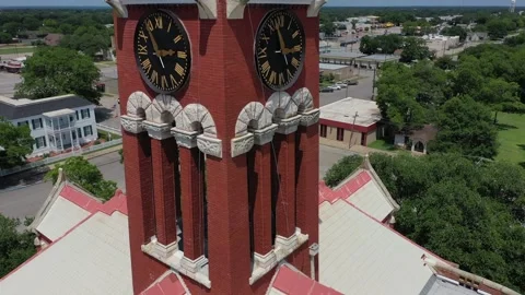 Details in a Clocktower, with flags and a Downtown Church, Giddings, Texas, USA Stock Footage 142107060