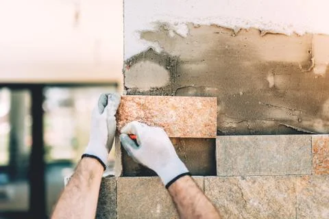 Details close up of construction builder working with stone and paving Stock Photos