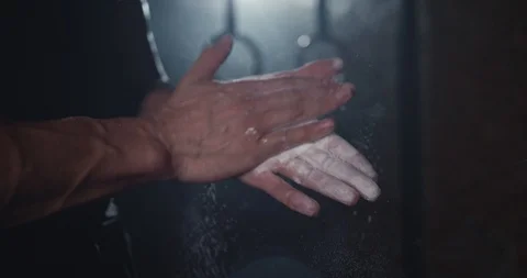 Details closeup athletic guy using powder before starting his training workout Stock Footage 125481054