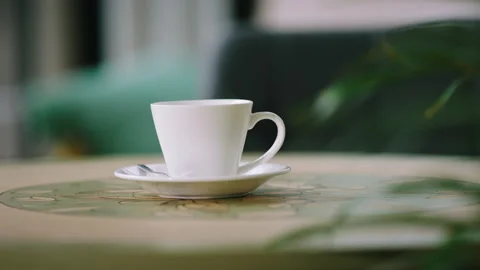 Details closeup to the camera of a cup of tea or coffee standing on the table in Stock Footage 210783242