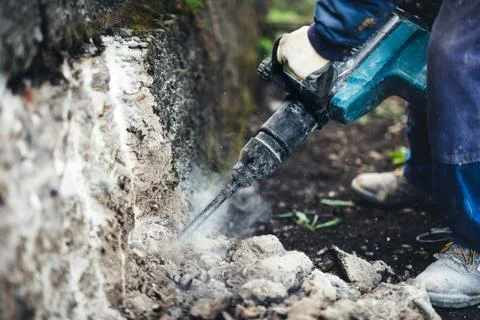 Details of construction site with worker using pneumatic jackhammer Stock Photos