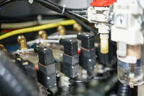 Details of electrical components connected to machinery in a workshop setti.. Stock Photos