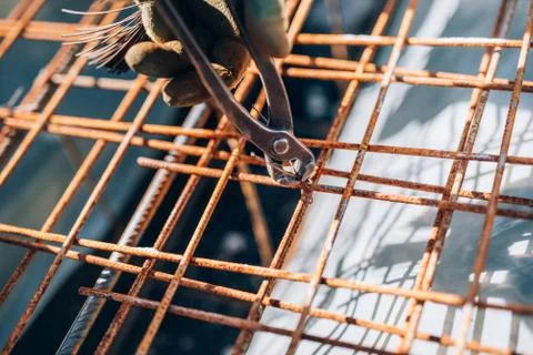 Details of infrastructure - Construction worker hands securing steel bars Stock Photos