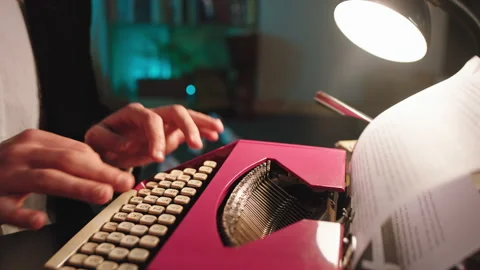 Details of a man type some text using a old typewriter in front of the camera Stock Footage 136548117