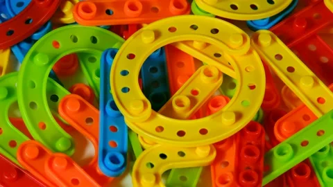 The details of the multi-colored plastic construction kit rotate. Top view. 스톡 동영상 155082292