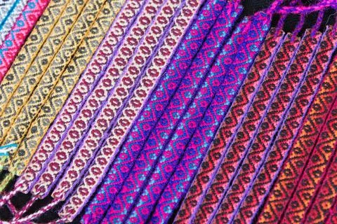 Details of multicolored handmade bracelets using alpaca fabrics and wool Foto stock