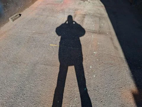 Details of a shadow, reflected on the floor. Stock Photos