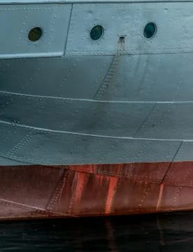 Details of the side of a grey steel plate ship. Stock Photos