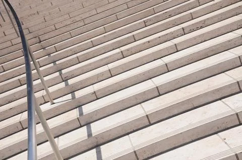 Details of a staircase made of light colored blocks, next to a wall Stockfoto's