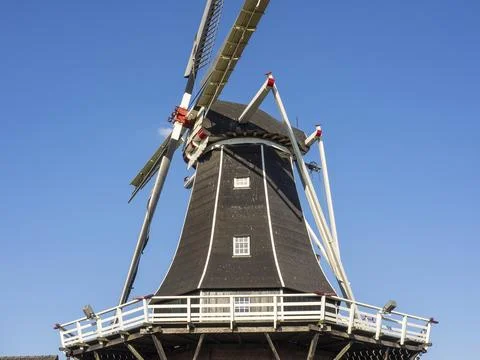 Details of the upper structure of a windmill under a clear sky, radiating calm, Stock Photos