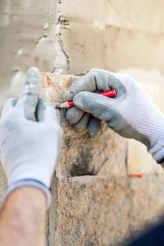 Details of worker hands taking notes and drawing on stone. Construction worker Stock Photos